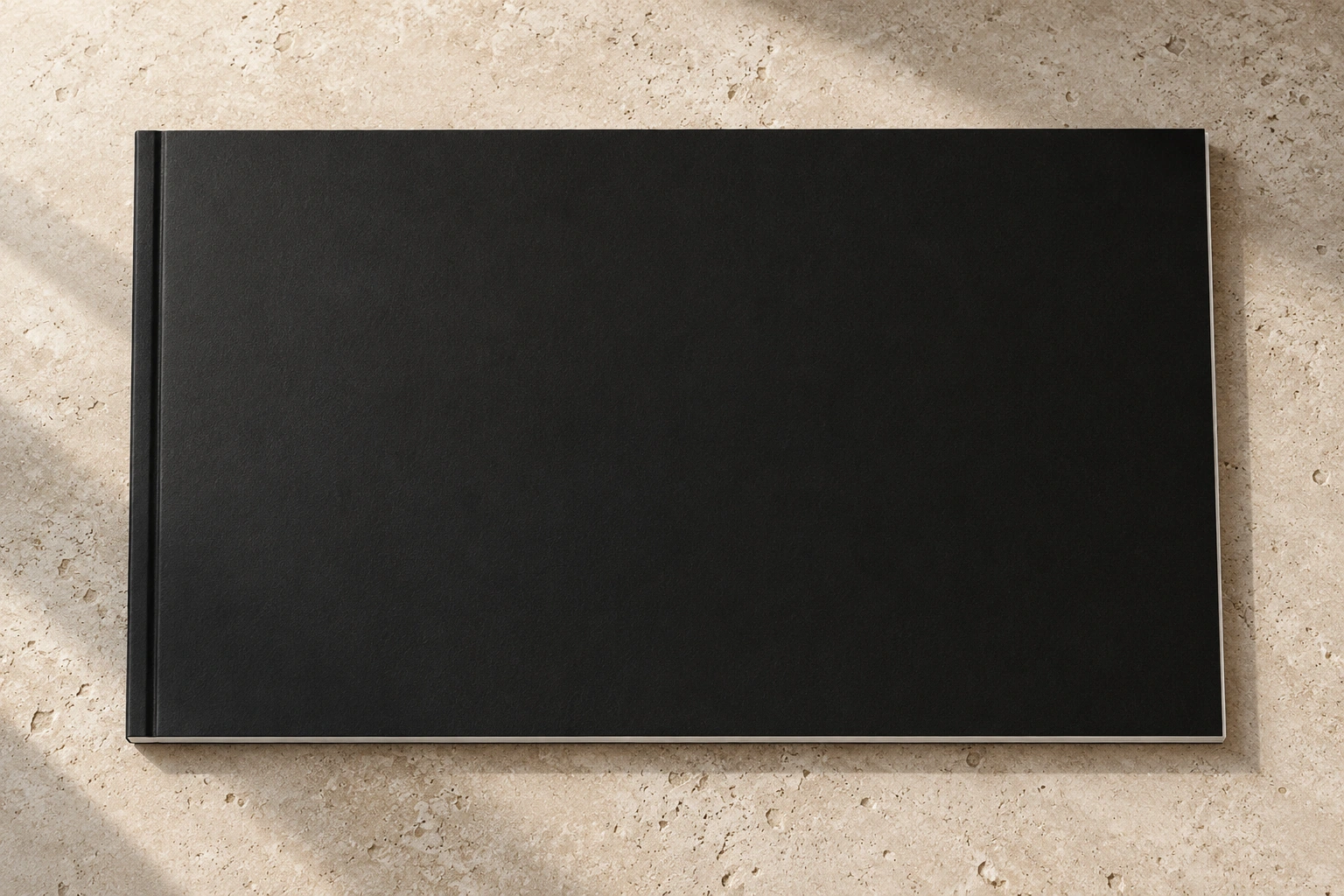 Printed catalogue photographed on a pale stone surface